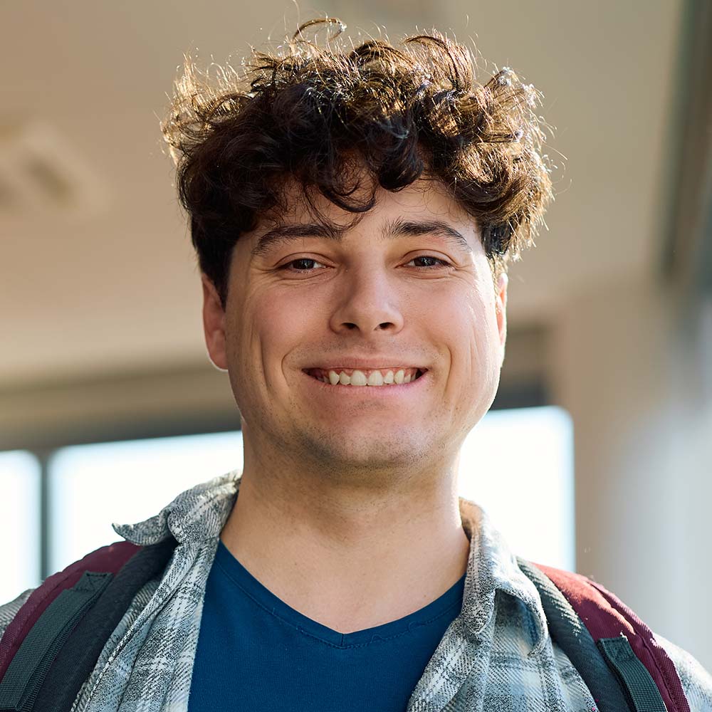 Home 11 happy student at university classroom looking at c TZ5ZT5G